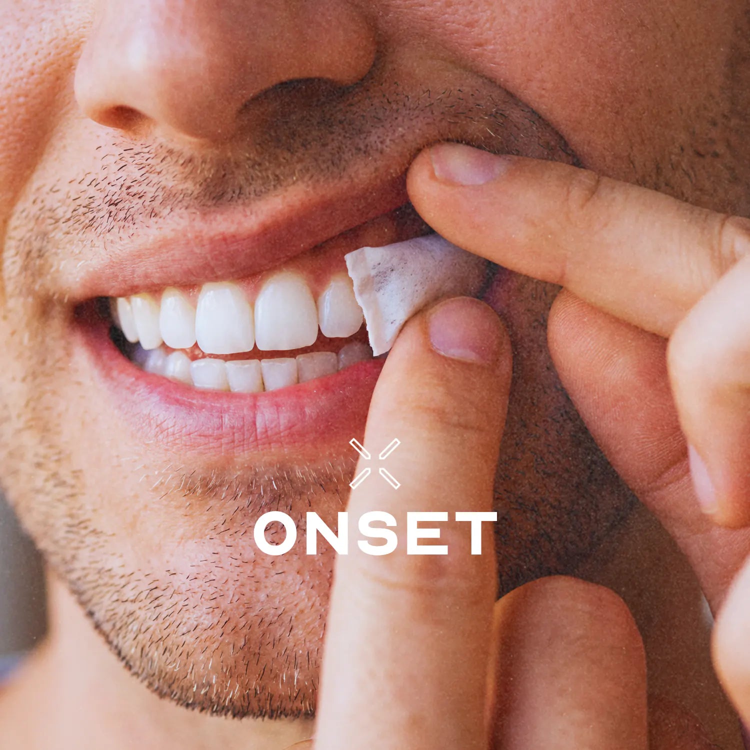 A close crop of a man tucking a white pouch behind his upper lip